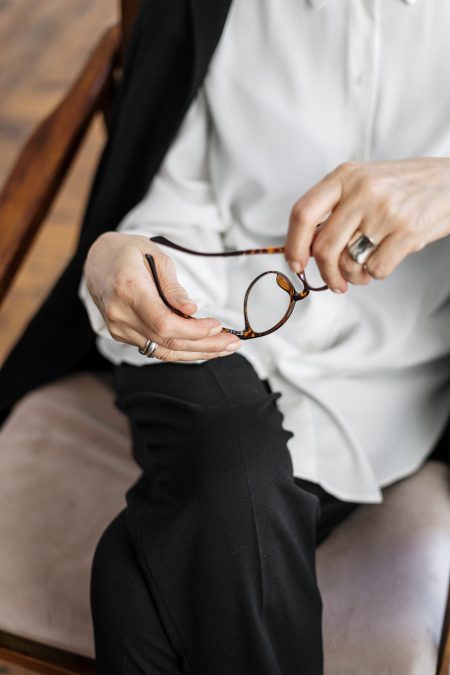 Woman holding eyeglasses